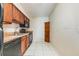 Efficient kitchen featuring wood cabinets and black appliances at 706 Haven Pl, Tarpon Springs, FL 34689