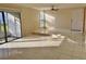 Sunlit living room with tile floors and views of the patio and backyard at 706 Haven Pl, Tarpon Springs, FL 34689