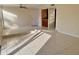 Open living area with tile floors, access to kitchen and patio, and a raised sitting area at 706 Haven Pl, Tarpon Springs, FL 34689