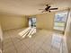 Bright living room with tile floors and sliding glass doors leading to a patio at 706 Haven Pl, Tarpon Springs, FL 34689