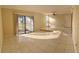 Spacious living room featuring tile floors, a raised seating area, and access to a patio at 706 Haven Pl, Tarpon Springs, FL 34689