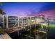 Covered boat lift with two boats, providing convenient and protected water access at 899 Bay Esplanade, Clearwater Beach, FL 33767