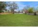 Large backyard with spacious lawn and wood fence at 908 Victoria St, Brandon, FL 33510