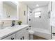 Updated bathroom with white vanity and bathtub at 908 Victoria St, Brandon, FL 33510