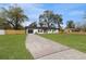 Newly renovated home with driveway and grassy yard at 908 Victoria St, Brandon, FL 33510