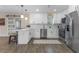 Modern kitchen featuring white cabinets, stainless steel appliances, and tile floors at 908 Victoria St, Brandon, FL 33510