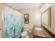 Clean bathroom with granite vanity and teal shower curtain at 10033 64Th N Ave # 16, St Petersburg, FL 33708
