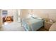 Charming bedroom with light blue bedding and wicker furniture at 10033 64Th N Ave # 16, St Petersburg, FL 33708