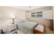 Well-lit bedroom with light blue bedding and wooden accents at 10033 64Th N Ave # 16, St Petersburg, FL 33708