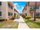 Exterior of condo building with walkway, landscaping, and building number signage at 10033 64Th N Ave # 16, St Petersburg, FL 33708