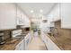 Kitchen with white cabinets, granite counters, and stainless steel sink at 10033 64Th N Ave # 16, St Petersburg, FL 33708