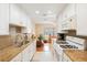 Bright kitchen features granite countertops and white cabinetry at 10033 64Th N Ave # 16, St Petersburg, FL 33708