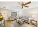 Living room with light wood floors, sofa, and ceiling fan at 10033 64Th N Ave # 16, St Petersburg, FL 33708