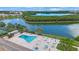 Community pool with plenty of lounge chairs and hot tub at 10033 64Th N Ave # 16, St Petersburg, FL 33708