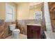 Updated bathroom with granite countertop and brown tile at 1198 40Th Ne Ave, St Petersburg, FL 33703