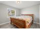 Bedroom with wood bed frame and light grey walls at 1198 40Th Ne Ave, St Petersburg, FL 33703