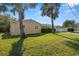 Tan house exterior with palm trees at 1198 40Th Ne Ave, St Petersburg, FL 33703