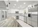 Modern white kitchen with stainless steel appliances and granite island at 1198 40Th Ne Ave, St Petersburg, FL 33703