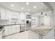 Modern kitchen with white cabinets, granite counters and stainless steel appliances at 1198 40Th Ne Ave, St Petersburg, FL 33703