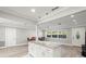 Open concept kitchen with granite island and white cabinetry at 1198 40Th Ne Ave, St Petersburg, FL 33703