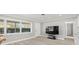 Bright living room with large TV and hardwood floors at 1198 40Th Ne Ave, St Petersburg, FL 33703
