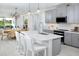 Modern kitchen with gray cabinets, white countertops, and an island at 12094 New Tranquility Path, Venice, FL 34293