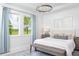 Bright bedroom with large windows, king-size bed, and benches at foot of bed at 12094 New Tranquility Path, Venice, FL 34293