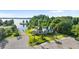 Aerial view of a waterfront home with lush landscaping and a private dock on a tranquil lake at 12405 Stonelake Ranch Blvd, Thonotosassa, FL 33592
