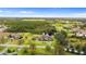 Scenic aerial view of a luxurious estate, showcasing lush landscaping and tranquil pond in a verdant setting at 12405 Stonelake Ranch Blvd, Thonotosassa, FL 33592
