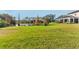 Expansive backyard featuring a large grassy area, picturesque pond, and inviting screened-in lanai at 12405 Stonelake Ranch Blvd, Thonotosassa, FL 33592