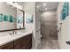 Bathroom with a vanity, large mirror and a walk-in shower at 12405 Stonelake Ranch Blvd, Thonotosassa, FL 33592