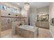 Large bathroom with soaking tub, walk-in shower, and double vanity at 12405 Stonelake Ranch Blvd, Thonotosassa, FL 33592