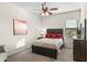 Comfortable bedroom featuring soft carpet, ceiling fan, and natural light at 12405 Stonelake Ranch Blvd, Thonotosassa, FL 33592