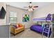 Bedroom with a bunk bed, a couch, and a wall-mounted television at 12405 Stonelake Ranch Blvd, Thonotosassa, FL 33592