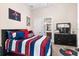 Youthful bedroom with a striped comforter and playful decor at 12405 Stonelake Ranch Blvd, Thonotosassa, FL 33592