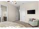 Bedroom with neutral colors, tv, and a connecting door to the bathroom at 12405 Stonelake Ranch Blvd, Thonotosassa, FL 33592