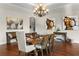 Bright dining room with hardwood floors, chandelier, and modern art at 12405 Stonelake Ranch Blvd, Thonotosassa, FL 33592