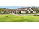 Elegant home exterior with well-manicured lawn and a circular driveway at 12405 Stonelake Ranch Blvd, Thonotosassa, FL 33592