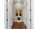 Bright hallway with hardwood floors and elegant wall art at 12405 Stonelake Ranch Blvd, Thonotosassa, FL 33592