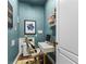 Stylish home office with a teal accent wall and built-in shelving at 12405 Stonelake Ranch Blvd, Thonotosassa, FL 33592