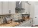 Stylish kitchen with hexagonal backsplash and granite countertops at 12405 Stonelake Ranch Blvd, Thonotosassa, FL 33592