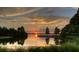 Beautiful sunset over a serene lake, framed by trees and lush vegetation at 12405 Stonelake Ranch Blvd, Thonotosassa, FL 33592