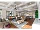 Sunlit living room with hardwood floors, comfortable seating, and open floor plan at 12405 Stonelake Ranch Blvd, Thonotosassa, FL 33592