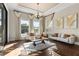 Bright living room with a large windows, hardwood floors, stylish decor, and a cozy rug at 12405 Stonelake Ranch Blvd, Thonotosassa, FL 33592