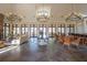 Spacious lounge featuring stone floors, elegant chandeliers, and large windows at 12405 Stonelake Ranch Blvd, Thonotosassa, FL 33592