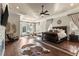 Spacious main bedroom featuring hardwood floors, a ceiling fan, and elegant decor for a luxurious retreat at 12405 Stonelake Ranch Blvd, Thonotosassa, FL 33592