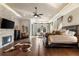 Luxurious main bedroom with fireplace, hardwood floors, and large windows at 12405 Stonelake Ranch Blvd, Thonotosassa, FL 33592