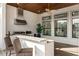 Outdoor kitchen with a grill, stainless steel range hood, and bar seating at 12405 Stonelake Ranch Blvd, Thonotosassa, FL 33592