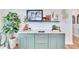Stylish home bar with green cabinets and marble countertop at 12940 Brookside Moss Dr, Riverview, FL 33579