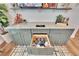 Home bar with green cabinets, marble countertop and open shelving at 12940 Brookside Moss Dr, Riverview, FL 33579